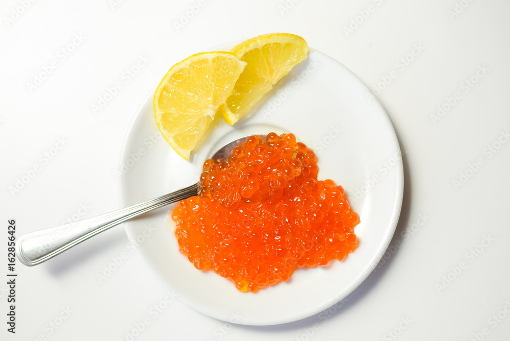 Closeup on red caviar delicacy on white plate, closeup light macro background Closeup on red caviar delicacy on white plate, closeup light macro background