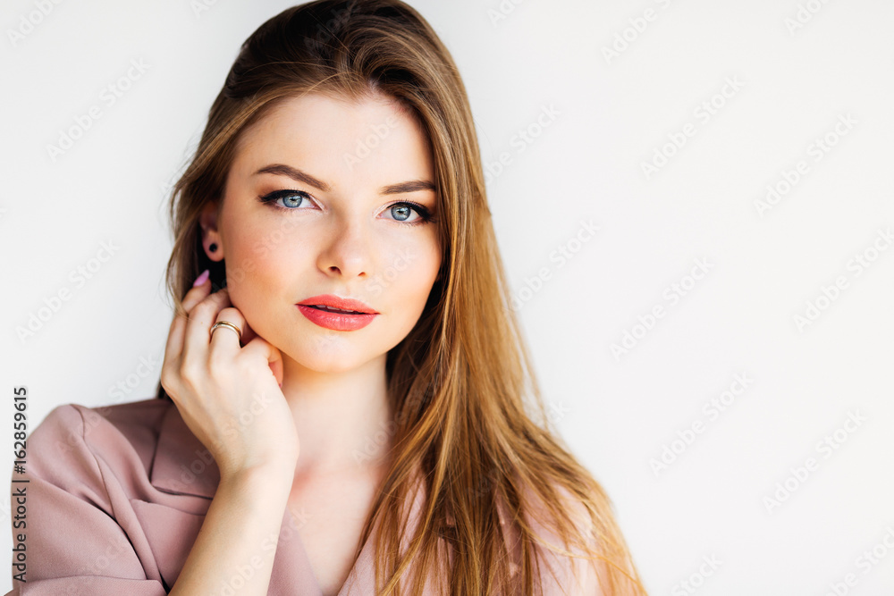Elegance lady with blond hair and blue eyes looking at the camera on white background Elegance lady with blond hair and blue eyes looking at the camera on white background