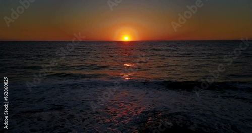 Brightly colored sunset over the calm Mediterranean Sea. Drone Point of View . Night	
