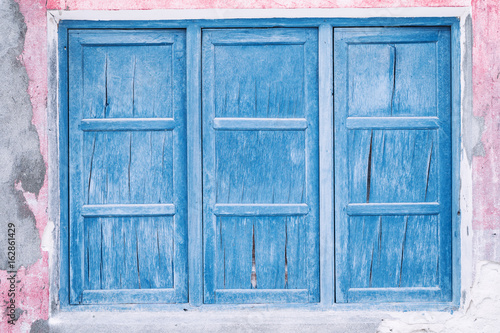 Old wooden closed window on maldivian house © photopixel