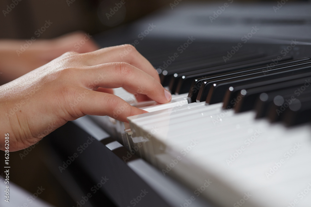 female's hands playing piano female's hands playing piano