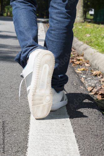 Human legs walking on a street