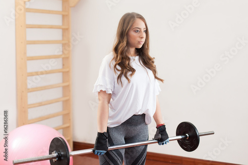 young woman preparing to weight lift