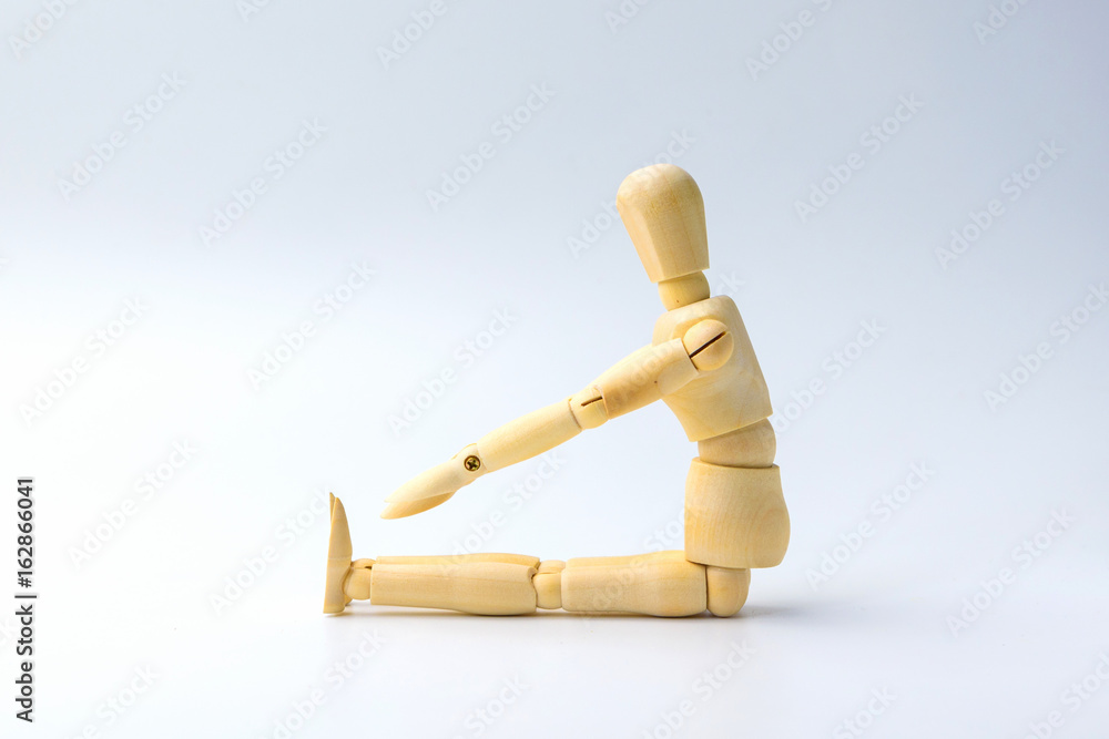 Wooden figure doll with Stretch arms and leg on white for exercise training and helth concept Wooden figure doll with Stretch arms and leg on white for exercise training and helth concept