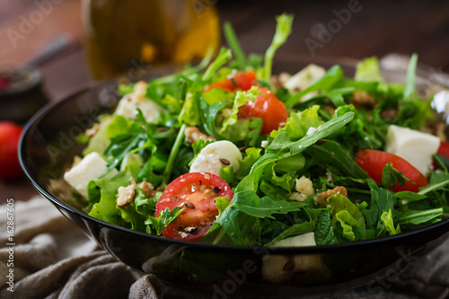 Vitamin Salad of fresh vegetables, herbs, feta cheese and nuts. Dietary menu. Proper nutrition.