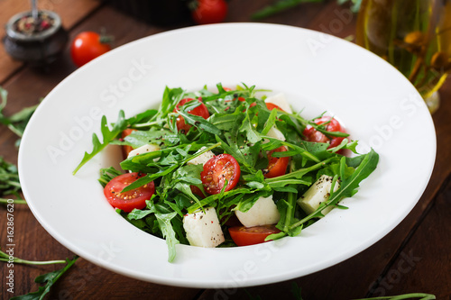 Vitamin Salad of fresh tomatoes, herbs, feta cheese and flax seeds. Dietary menu. Proper nutrition.