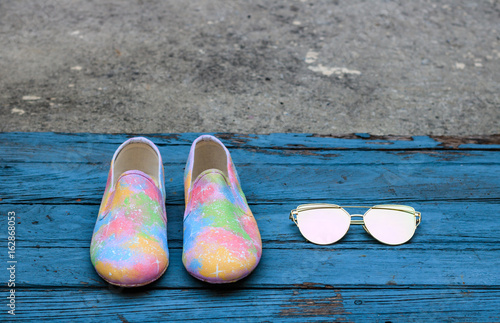 Pair of female summer shoes and sunglasses photo