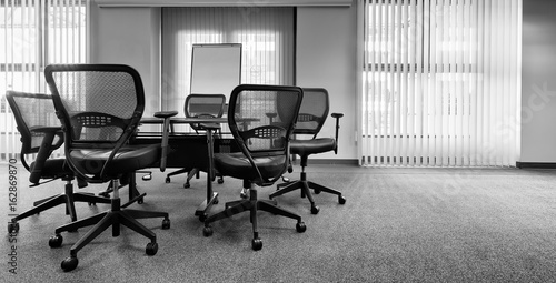 Fototapeta Ergonomic office chairs around a small conference table