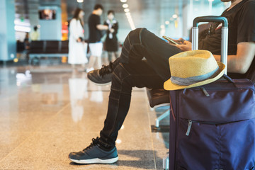 Young traveler using smartphone while waiting at the airport