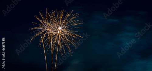 Fotografie, Tablou Orange Fireworks Blue Background