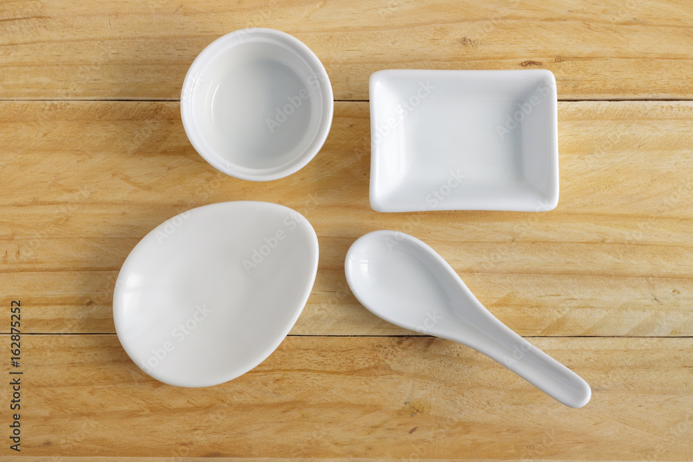 white ceramic ware on wooden table, top view white ceramic ware on wooden table, top view
