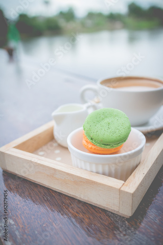 hot coffee breakfast set with fresh macaroon in outdoor bakery house cafe(vintage)