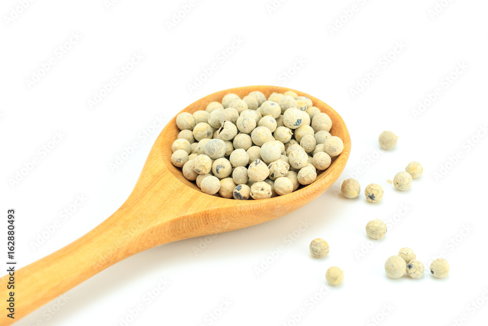 Peppercorn with wooden spoon on white background. Composition isolated over the white background. Peppercorn with wooden spoon on white background. Composition isolated over the white background.