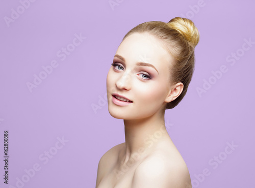 Beauty close-up portrait of beautiful, fresh and healthy girl over magenta background.