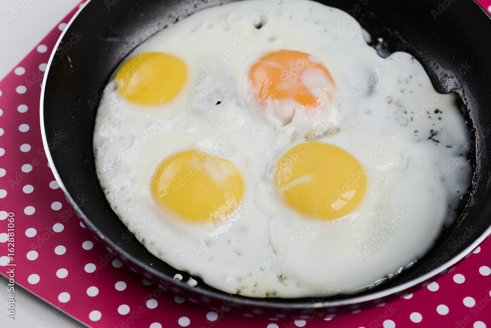 Delicious healthy simple breakfast meal made of eggs on a frying pan ready. Delicious healthy simple breakfast meal made of eggs on a frying pan ready.