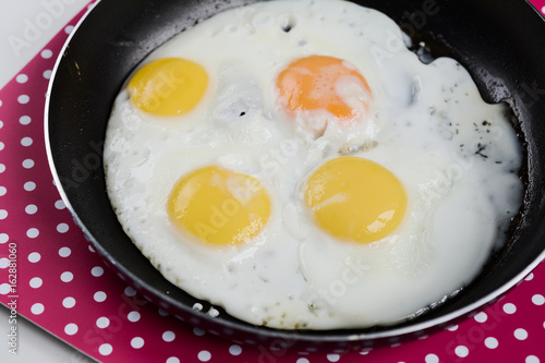 Delicious healthy simple breakfast meal made of eggs on a frying pan ready.