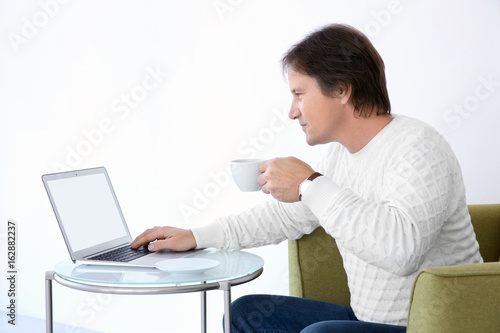 Mature man drinking tea and...