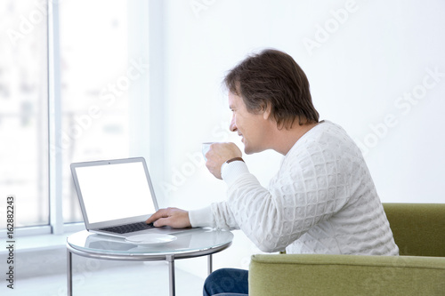 Mature man drinking tea and...