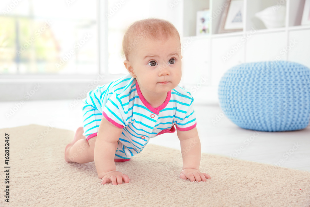 Cute little baby crawling on floor at home Cute little baby crawling on floor at home