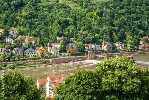 Plenty of residential houses at the hillside at the embankment of Neckar river at the center of Heidelberg, an aerial panoramic view over the roofs, Baden-Württemberg, Germany.