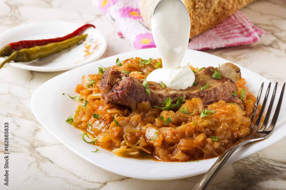 Cabbage stew with Smoked Pork Ribs, cream and green parsley Cabbage stew with Smoked Pork Ribs, cream and green parsley