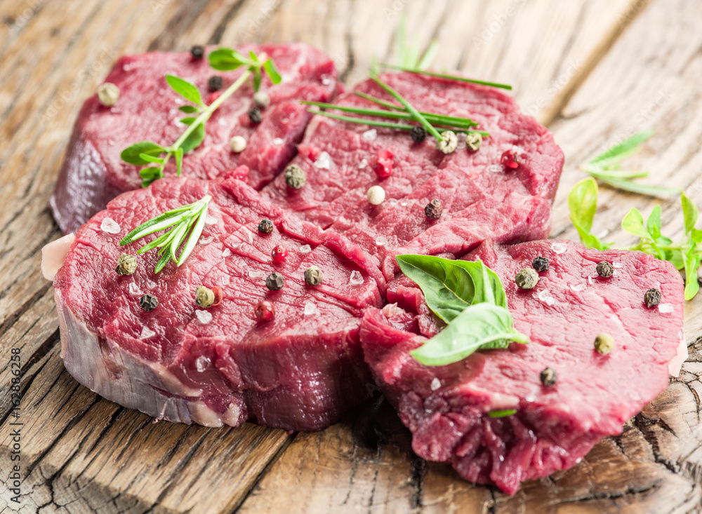 Pieces of beef tenderloin on the wooden cutting board. Pieces of beef tenderloin on the wooden cutting board.