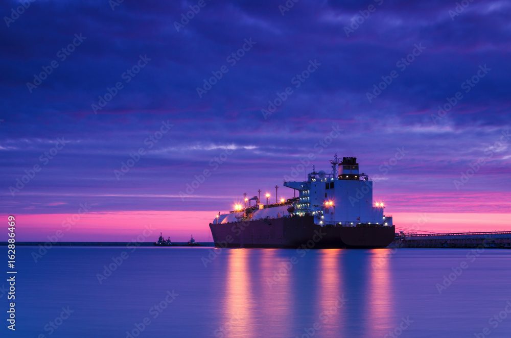 LNG TANKER AT DAWN - Sunrise over the gas terminal LNG TANKER AT DAWN - Sunrise over the gas terminal