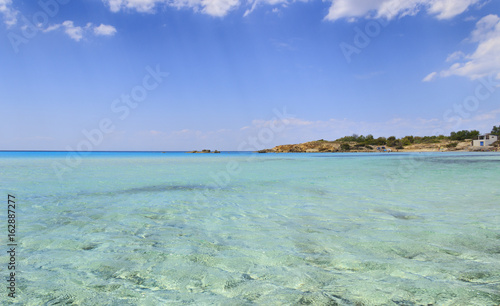Summer seascape,Apulia coast: Marina di Pulsano beach (Taranto). The coastline is characterized by a alternation of sandy coves and jagged cliffs overlooking a truly clear and crystalline sea (Italy).