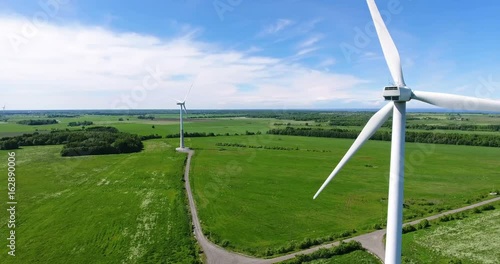 Flight around rotating blades of wind turbine. Onshore horizontal axis wind turbines photo