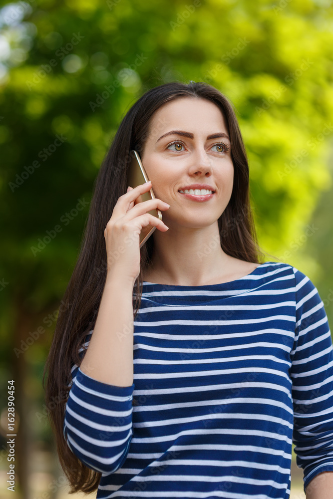 woman talking on phone in park