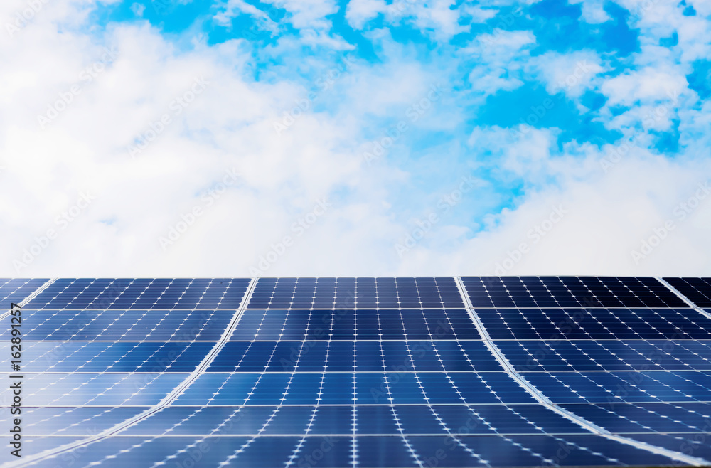Photovoltaic modules of solar panels with sky on background