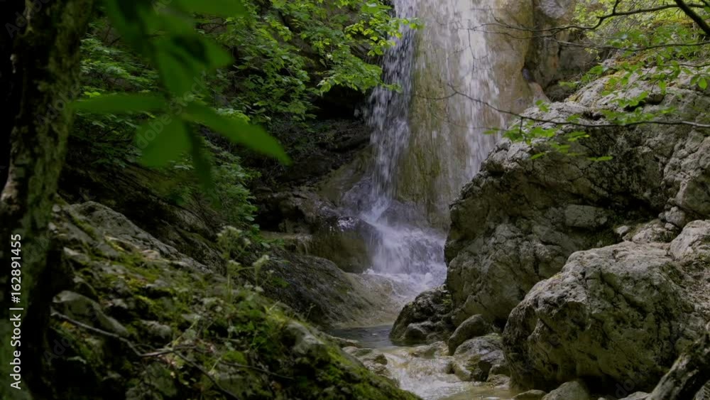 Waterfall in the forest among the rocks Waterfall in the forest among the rocks