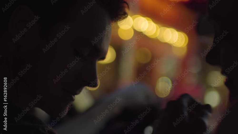 Couple Share An Intimate Moment In A Parked Car, City Lights In Background (Slow Motion) Couple Share An Intimate Moment In A Parked Car, City Lights In Background (Slow Motion)