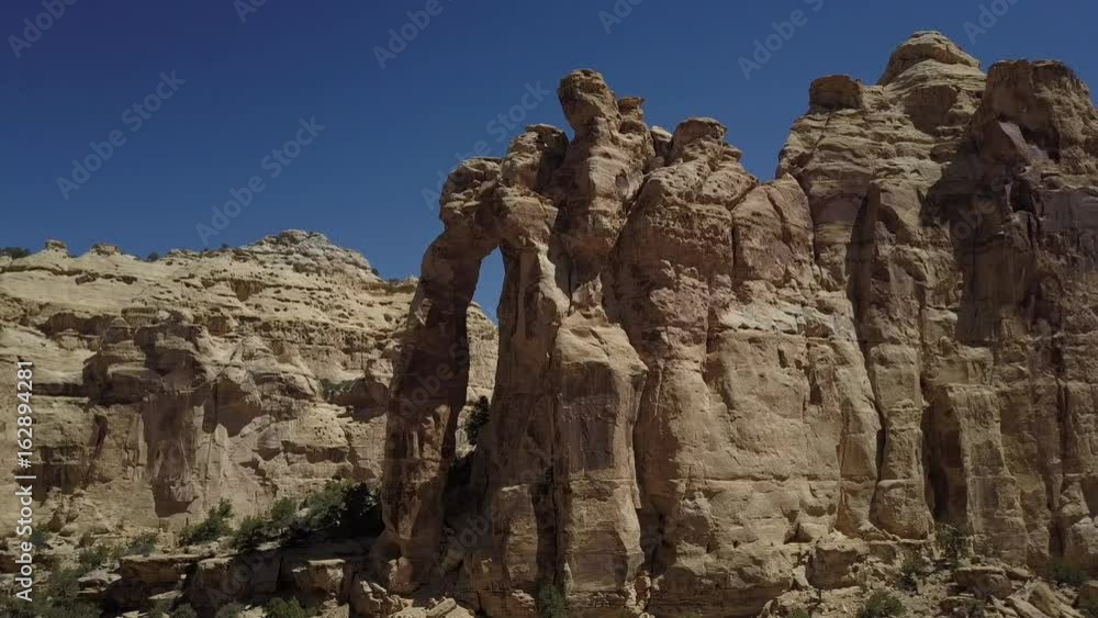 Aerial San Rafael Utah desert landscape Eagle Arch slide. Geologic desert landscape. Valleys, canyons, gorges and towers. Attracts hikers and off road all terrain vehicle 4x4 recreation.