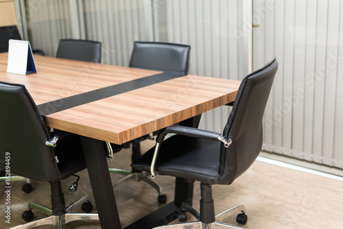 black leather office chair and table in the meeting room in selective focus.
