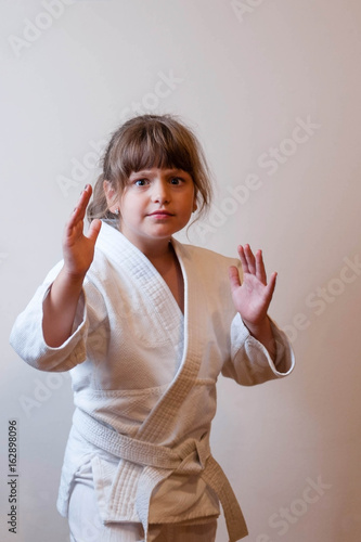 Judo girl posing in white judogi