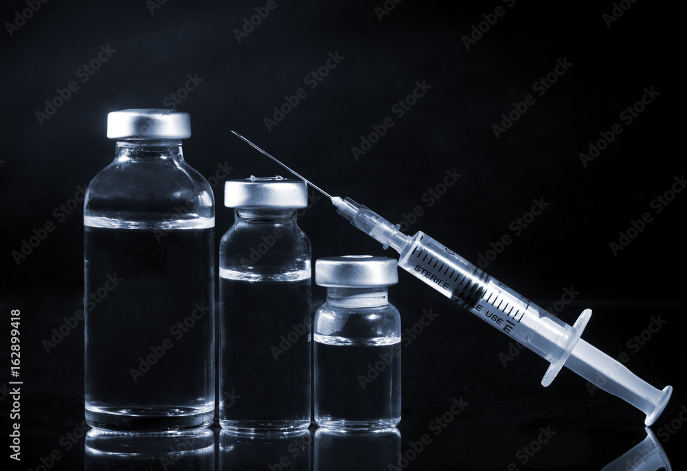 Glass Medicine Vials and Syringe. Tinted image. Glass Medicine Vials and Syringe. Tinted image.