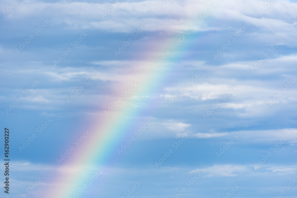 Natural rainbow and blue sky with clouds, nature background Natural rainbow and blue sky with clouds, nature background