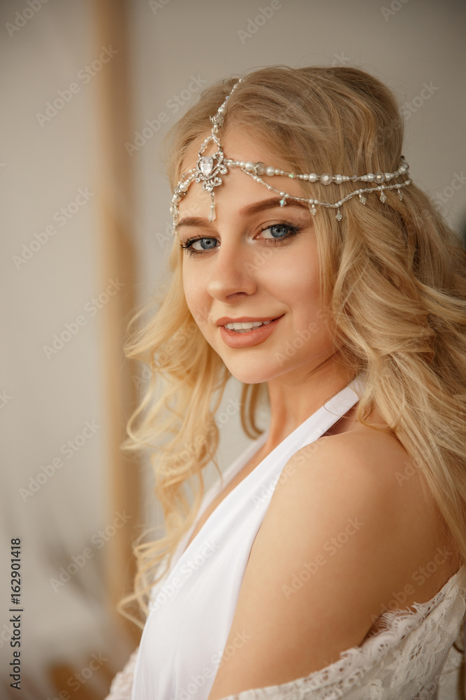 Portrait of beautiful woman, bride with wedding jewelry