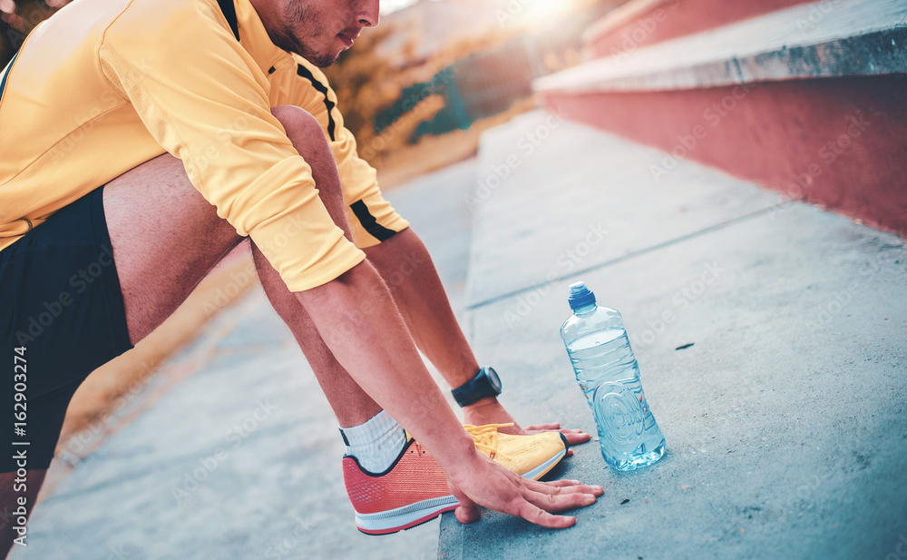 Fototapeta premium Sportsman stretching his body after training. Sport, fitness concept