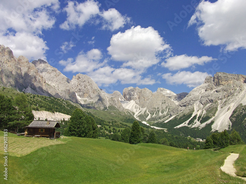 house in valley on high mountain blue sky view at dolomiten dolomites dolomiti dolomitet mountain Italy © Rinna8