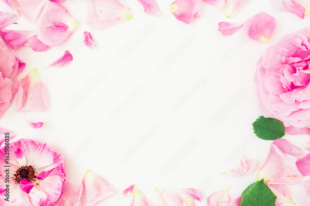 Round frame of pink flowers, petals and leaves on white background. Floral lifestyle composition. Flat lay, top view.