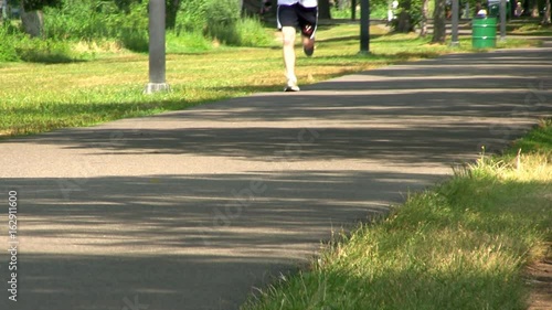 Path along Charles river in Boston provides perfect place to jog, exercise or just enjoy nature and outdoors on summer day away from the hustle and bustle of city. photo