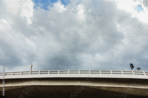 view of the bridge from the ground with cloudy sky