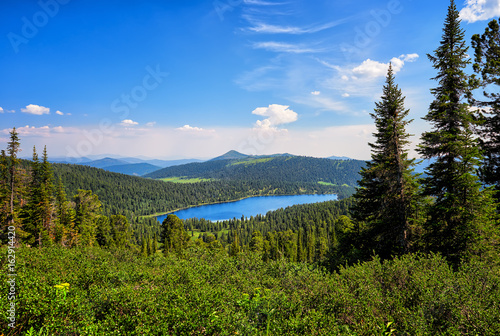 Lake in dark coniferous taiga. Nature Park Ergaki.