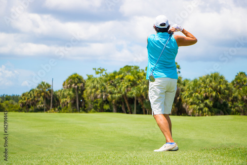 Golfer Hitting Ball on Beautiful Golf Course 