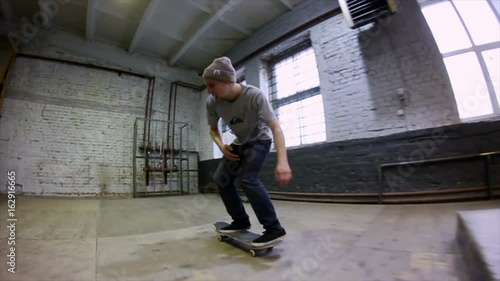 Wallpaper Mural Guy does a trick on a skateboard in a skate park. Slow motion Torontodigital.ca