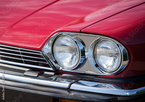 Headlights red vintage car close up © shishkin137