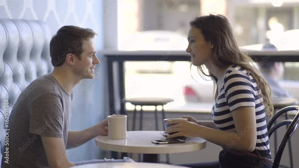 Happy Couple Enjoy Coffee, They Cheers And Share A Cute Moment Together