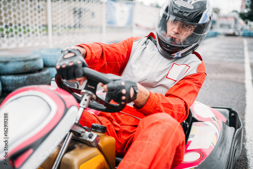 Karting race, go cart driver in helmet